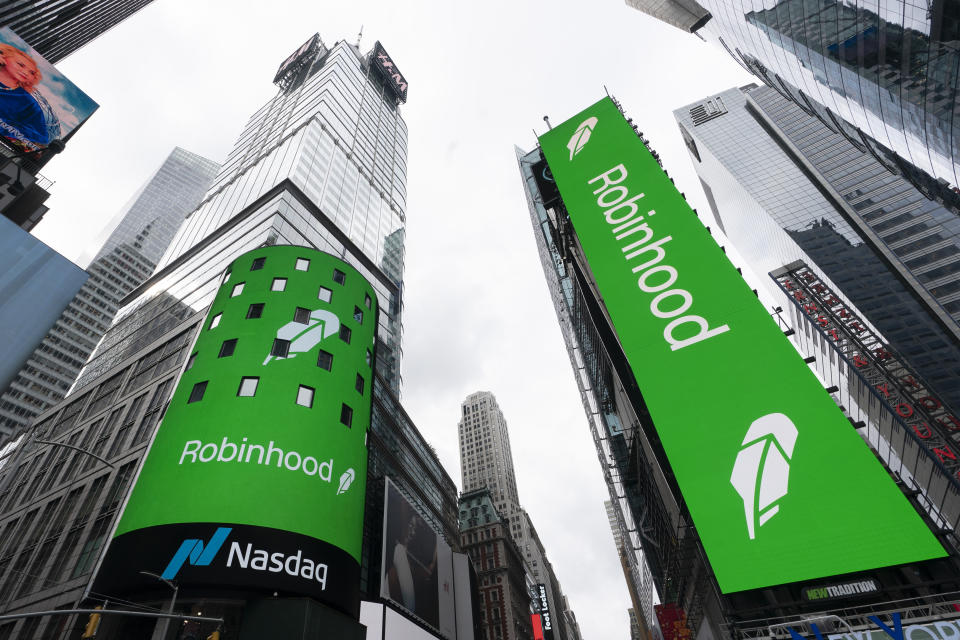 FILE - Electronic screens in New York's Times Square announce Robinhood's IPO, July 29, 2021. Robinhood Markets Inc. has received a notice from the Securities and Exchange Commission about alleged securities violations in its crypto division.  The company said in a regulatory filing that it has received investigative subpoenas from the SEC on matters including cryptocurrency listings, cryptocurrency custody and platform operations.  (AP Photo/Mark Lennihan, file)